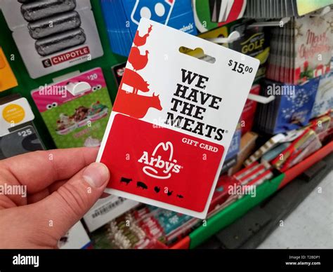 PLATTSBURGH, USA - JANUARY 21, 2019 : Arbys gift card in a hand over a ...