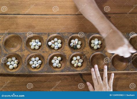 Hand Playing Marble Game. Marbles Game in Wooden Board Stock Image ...
