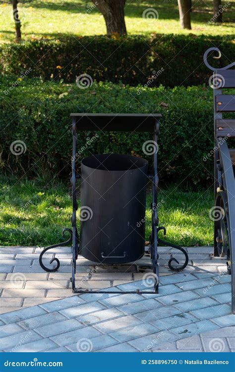 Iron Litter Bin in the Park. Garbage Can with Forged Patterns in the ...