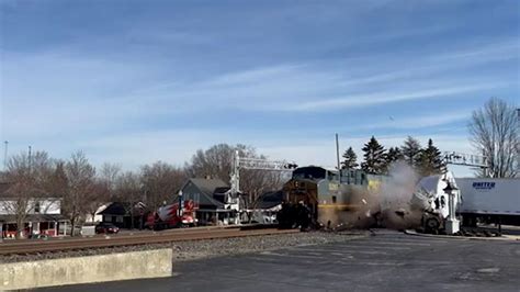 Truck driver safe after stranded semi gets plowed by train on tracks