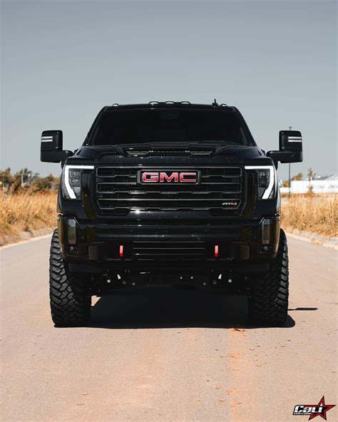 Black GMC Truck Driving on Road