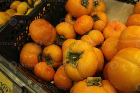 Persimmons of the kaki variety, flat persimmons close-up. Seasonal ...