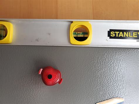 Heavy fridge was never properly leveled by delivery people. Cabinets ...