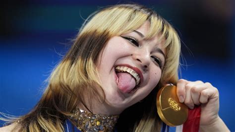Feb 19, 2026; Milan, Italy; Alysa Liu of the United States celebrates with the gold medal in the women's free skate during the Milano Cortina 2026 Olympic Winter Games at Milano Ice Skating Arena. Mandatory Credit: James Lang-Imagn Images