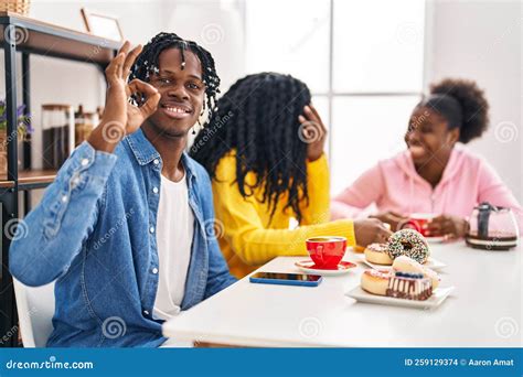 Group of Three Young Black People Sitting on a Table Having Coffee ...
