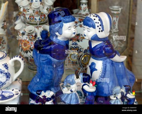 Display of Delftware or Delft blue pottery of kissing couples, dressed ...