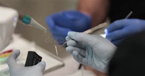 Dentist carrying out dental procedure on male patient, close-up