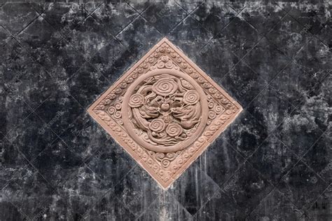 Premium Photo | Black tiles floor with brown stone carving of dragons