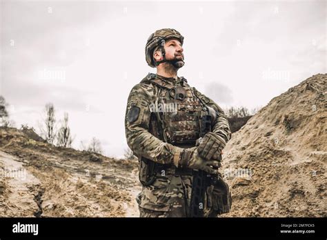 Mature man in military uniform and protective hemlet Stock Photo - Alamy