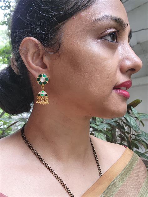 Gold polish kundan & emerald jhumkas with gold beads I House of Taamara