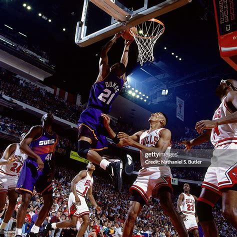 Richard Dumas of the Phoenix Suns attempts a dunk against Scottie ...