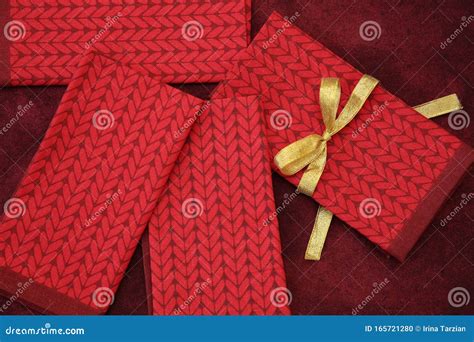 Red Fabric Napkins with a Gold Ribbon on a Red Tablecloth. Holiday ...