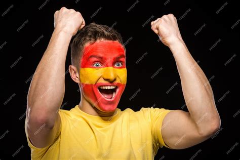 Flag of spain painted on a face man. | Premium Photo