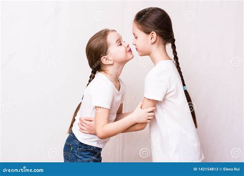 Two Girls Sisters Kiss Each Other when Meeting Stock Image - Image of ...