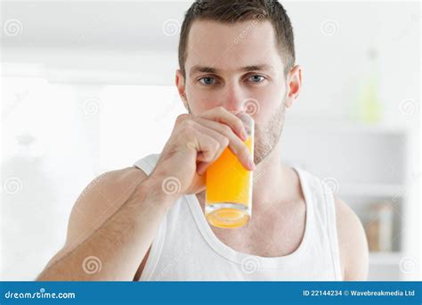 Serene Man Drinking Orange Juice Stock Photo - Image of holding, drink ...