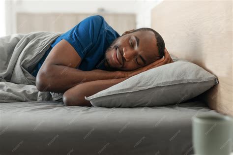 Premium Photo | Happy African Man Sleeping Lying In Cozy Bed In Bedroom