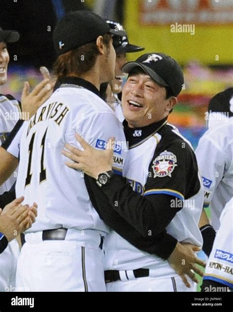 SAPPORO, Japan - Nippon Ham Fighters manager Masataka Nashida (R) hugs ...