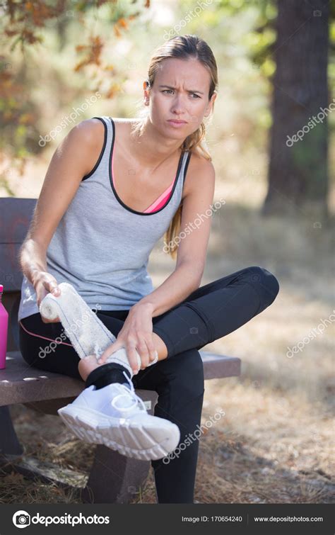 Fitness woman suffering painful ankle sprain injury after running ...