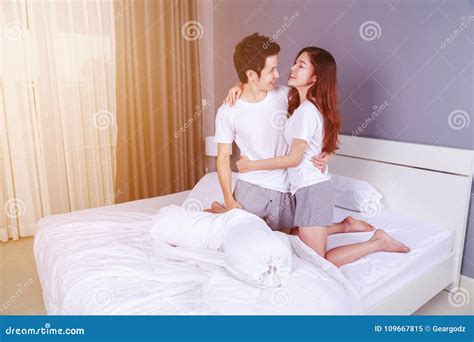 Happy Young Attractive Couple Hugging on Bed in Bedroom Stock Image ...