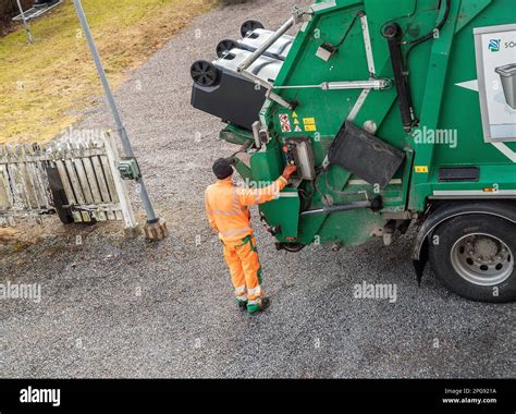 garbage truck driver empty trash in malmkoping sweden Stock Photo - Alamy