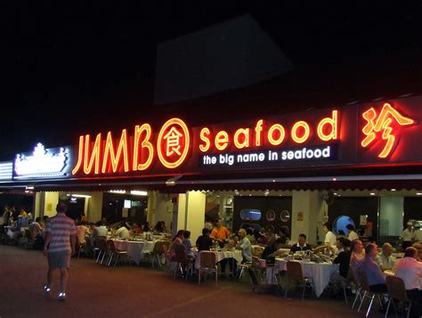 East Coast Seafood Centre in Singapore at night with outdoor dining tables and seafood restaurant lights