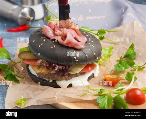 tasty black Burger with beef, bacon, cheese and vegetables Stock Photo - Alamy