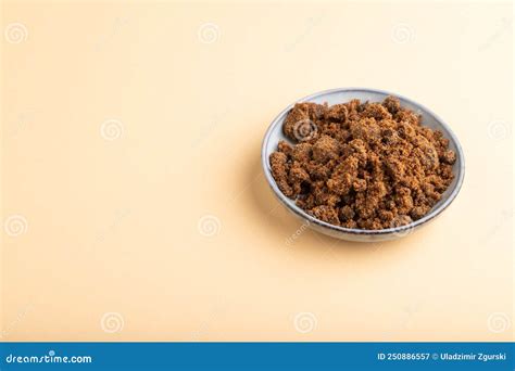 Plate with Unrefined Cane Sugar on Orange Pastel. Side View, Copy Space ...