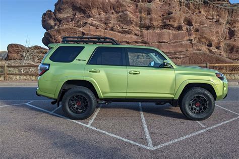 Download A Green Toyota 4runner Parked In A Parking Lot | Wallpapers.com