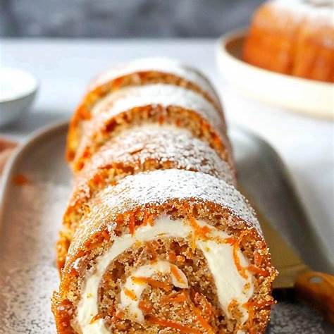 https://thatovenfeelin.com/wp-content/uploads/2024/08/Carrot-Cake-Roll-with-Cream-Cheese-Frosting-Filling-1.png