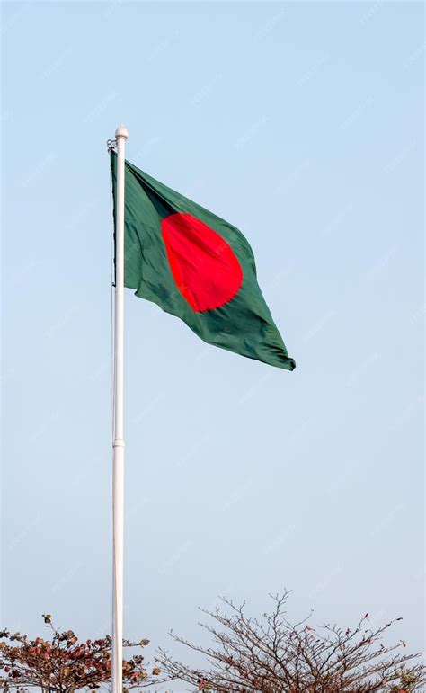 Premium Photo | National flag of bangladesh waving under the blue sky
