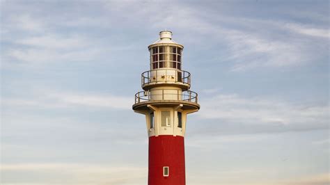 Wallpaper lighthouse, structure, grass, striped hd, picture, image