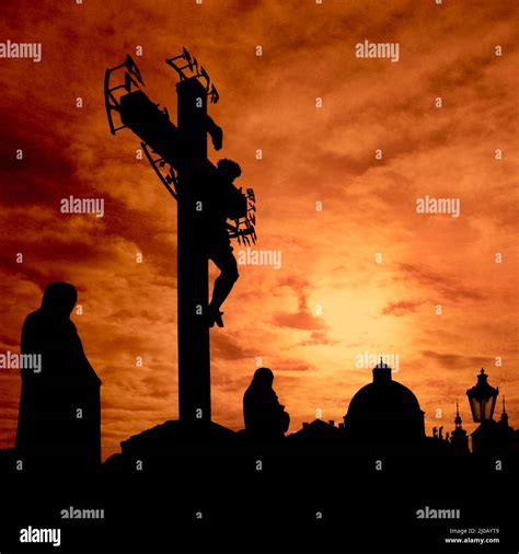 Dark silhouettes of Jesus Christ and monks are standing against burning red sunrise at Charles ...