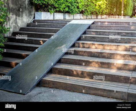 Plank wood stair outdoor with wooden wheelchair ramp on green tree ...