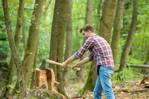 Premium Photo | Just one hit. chopping and splitting firewood with axe ...