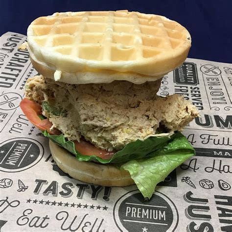 A promo photo for a “chicken and waffles” sandwich posted by a cafe ...