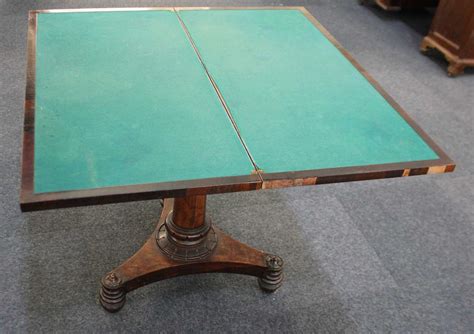 A 19th century rosewood card table, rectangular swivel top enclosing ...