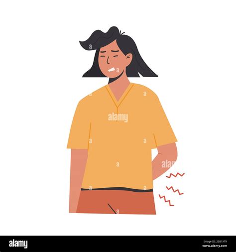 Young woman suffering from lower back pain while holding her side in ...