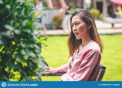 The Girl Sitting at the Chair is Absent-minded. Stock Photo - Image of ...