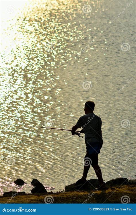 Sunset fishing silhouette editorial stock image. Image of leisure - 129530339