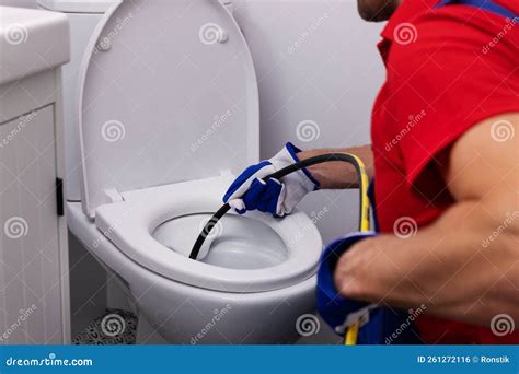 Plumber Unclogging Blocked Toilet with Hydro Jetting at Home Bathroom ...