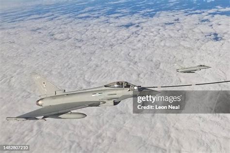 Royal Air Force ground crew preparing an RAF Typhoon fighter jet. It is night-time and the team are