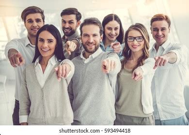 Group of People Standing in Office Pointing 的图像结果