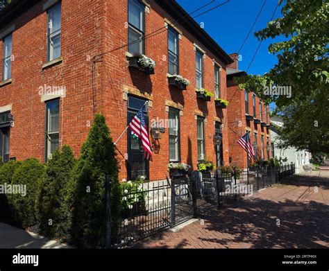 Old residential buildings along brick sidewalks maintain an old world ...