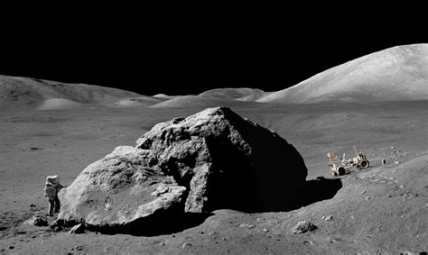 Astronaut Harrison Schmitt next to a large boulder in the Taurus ...
