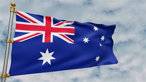 Australian flag fluttering in the wind on white clouds background, symbol of the country of ...