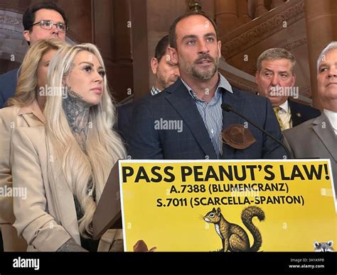 Mark Longo, center, and his wife Daniela Bittner, left, speak during a news conference at the ...