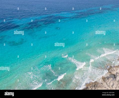 Aerial view of Ibiza, Spanish coast with white foamy waves on the ...