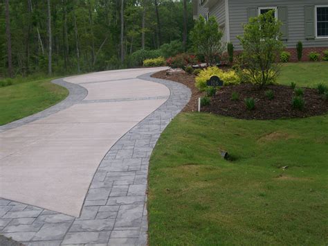 Concrete Stamped Border Driveway With Broom Finish Interior.