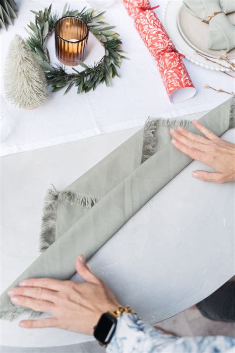 Christmas napkin folding technique: Fold your napkins into a bow