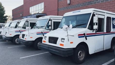 U.S. Postal Service (USPS) trucks are parked at a post office on August 23, 2024 in Glendale, Califo